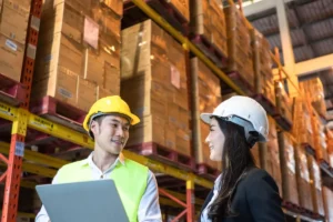 two warehouse worker conversing