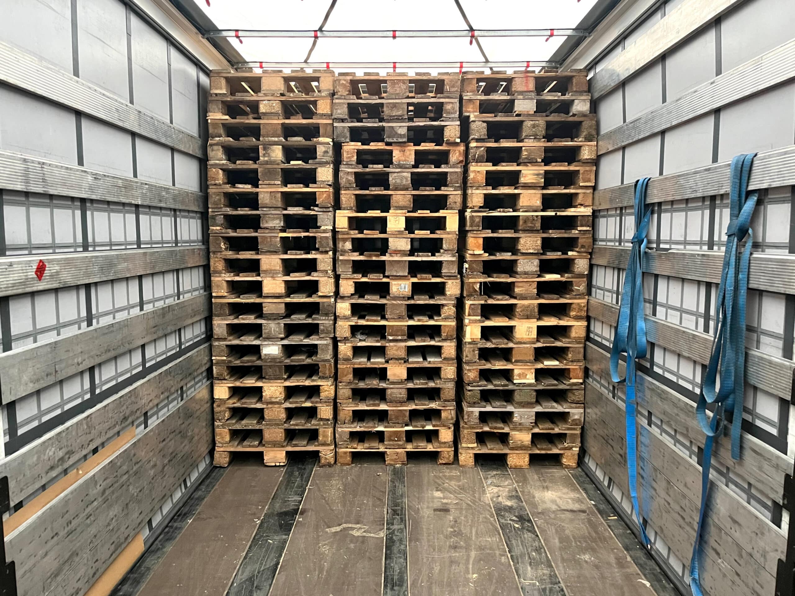 a pile of pallets inside a truck