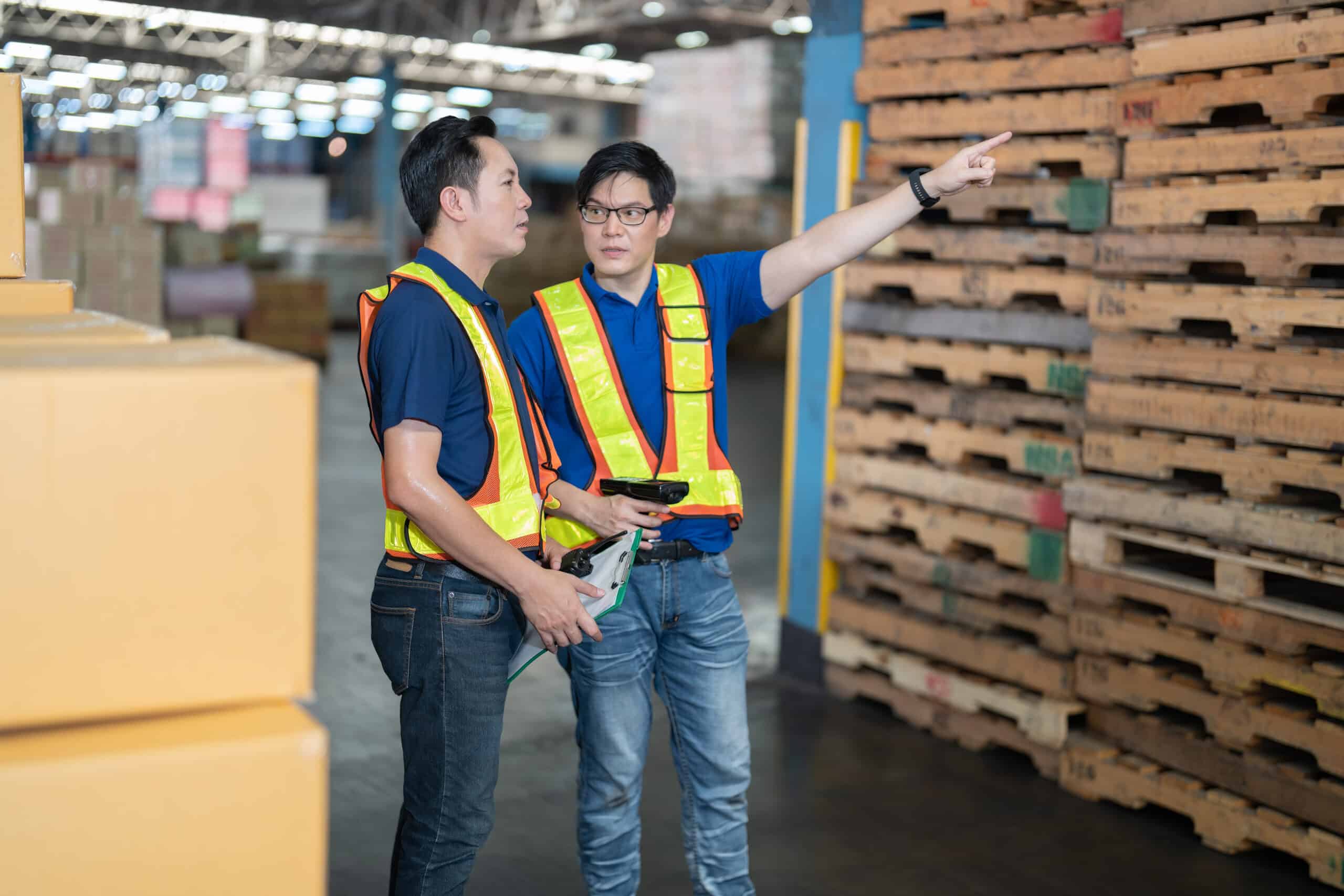 two warehouse workers discussing