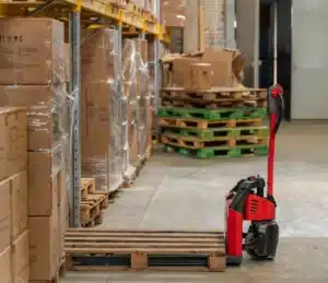 red handlift with enpty pallet on it